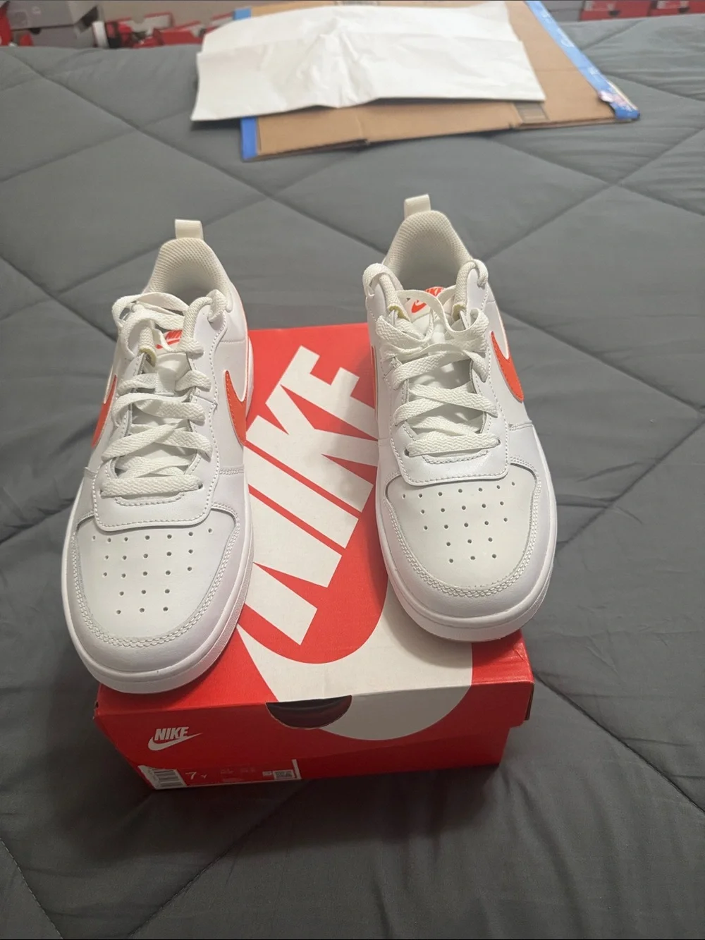 Nike Kids White Sneakers with Orange Swoosh Accent